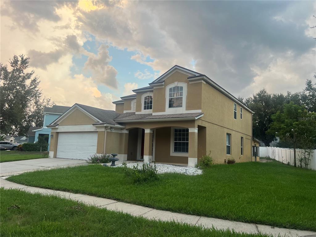 a front view of a house with a yard