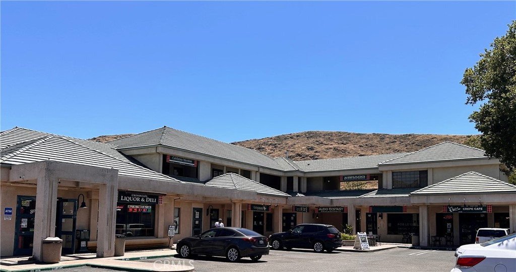 a view of a big building with cars parked