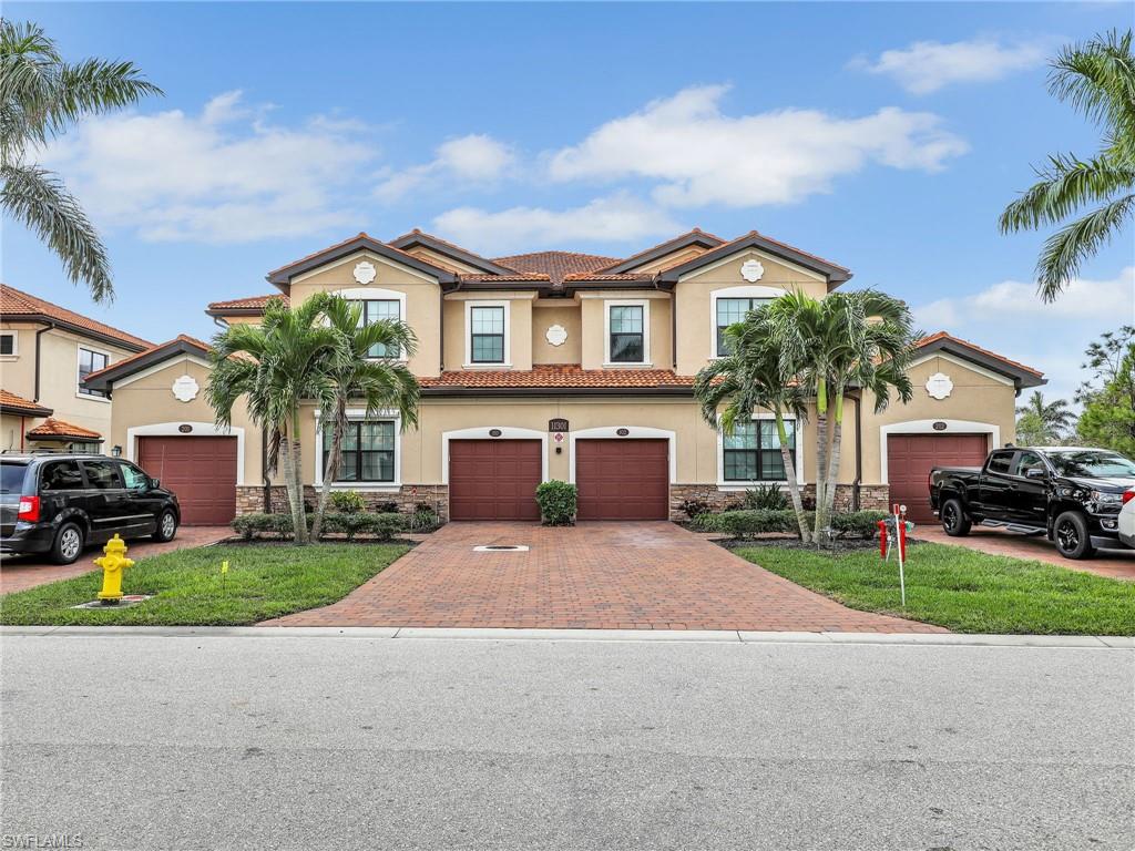 a front view of a house with a yard and garage