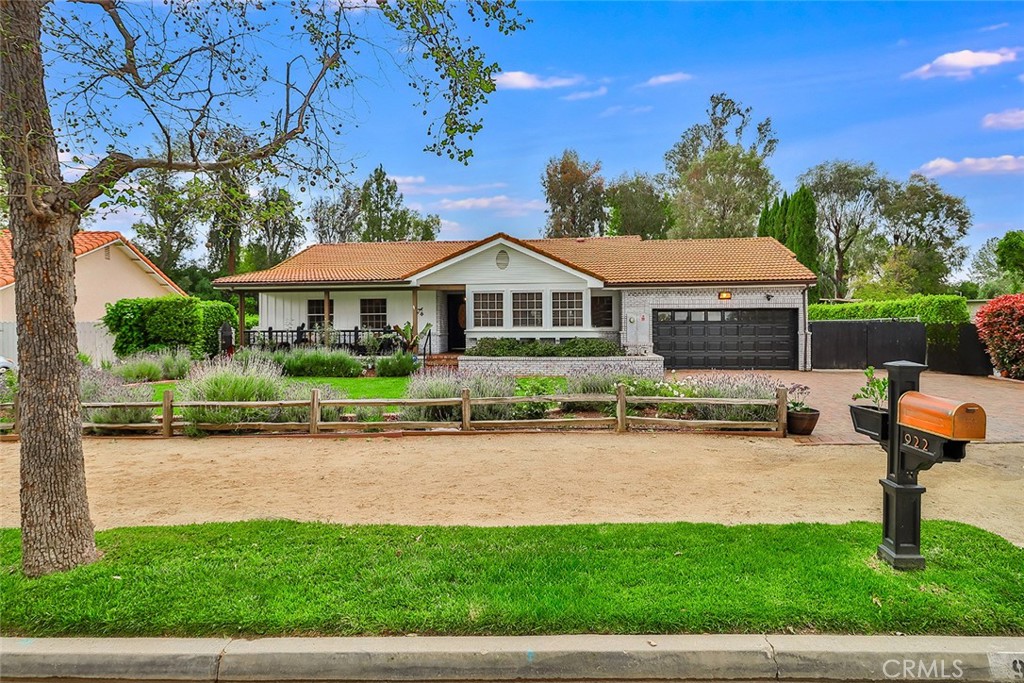 a front view of a house with a yard and lake view