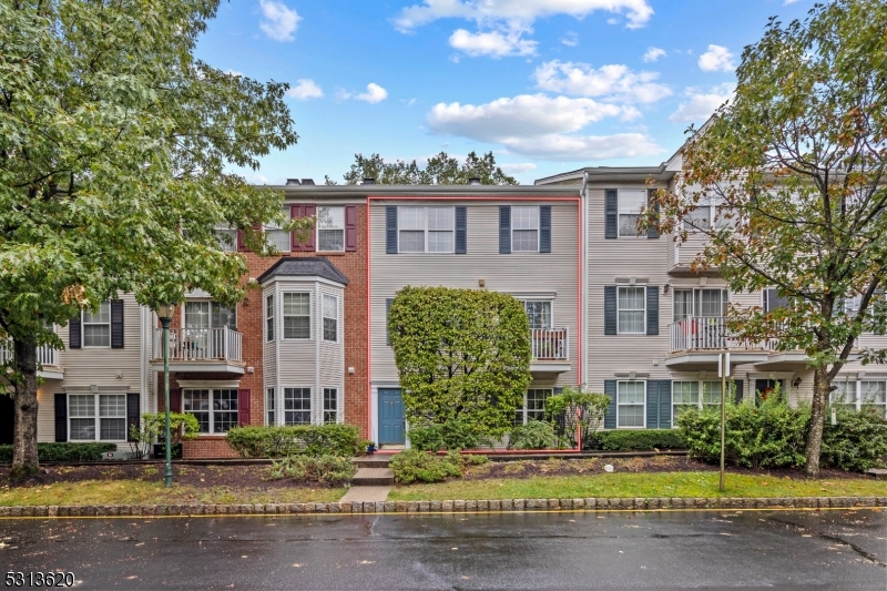 a front view of a residential apartment building with a yard