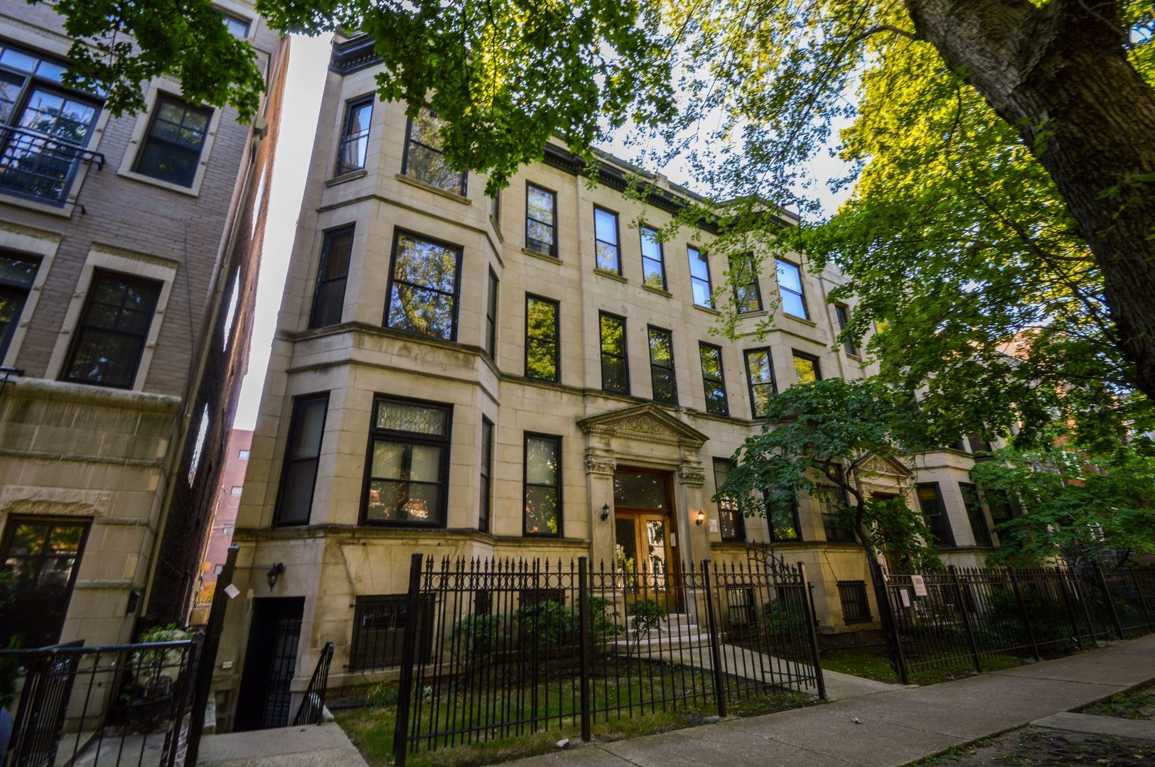 a front view of a residential apartment building with a yard