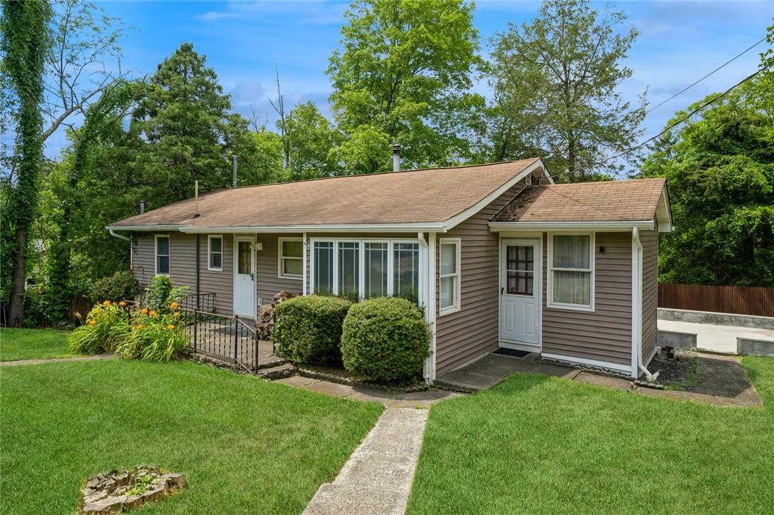 a view of house with a yard