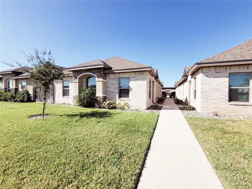 a front view of a house with a yard