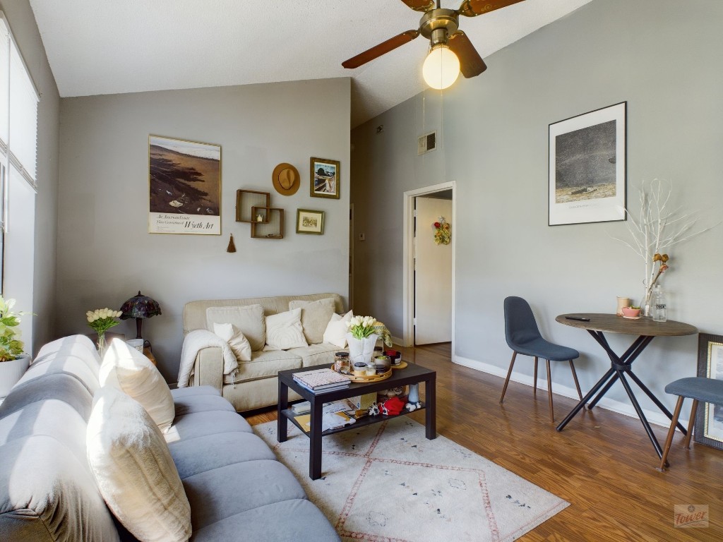 a living room with furniture and wooden floor