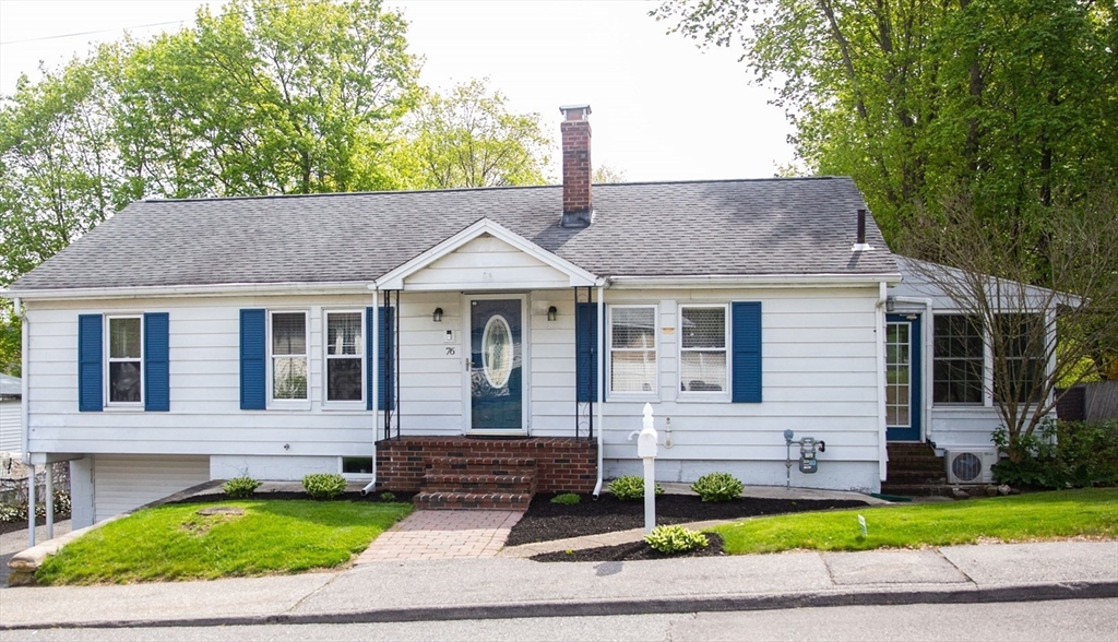 a front view of a house with a yard and outdoor seating