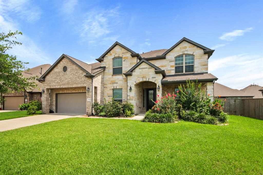 a front view of a house with a yard and garage