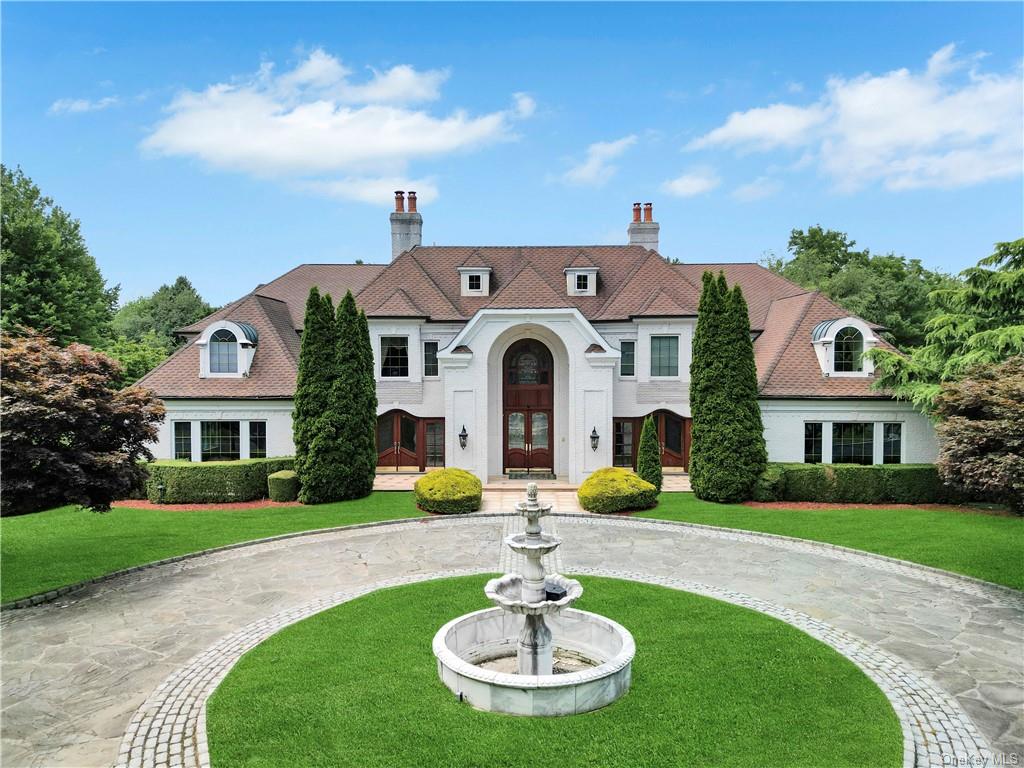 a front view of a house with swimming pool having outdoor seating