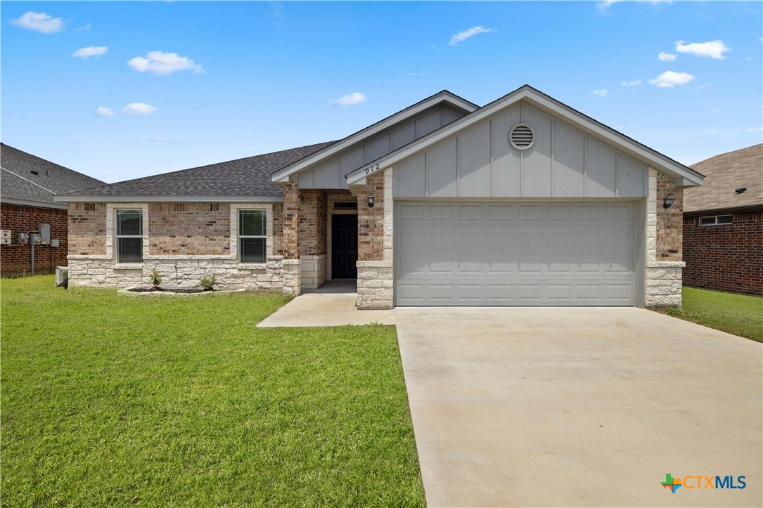 a front view of house with yard and outdoor seating