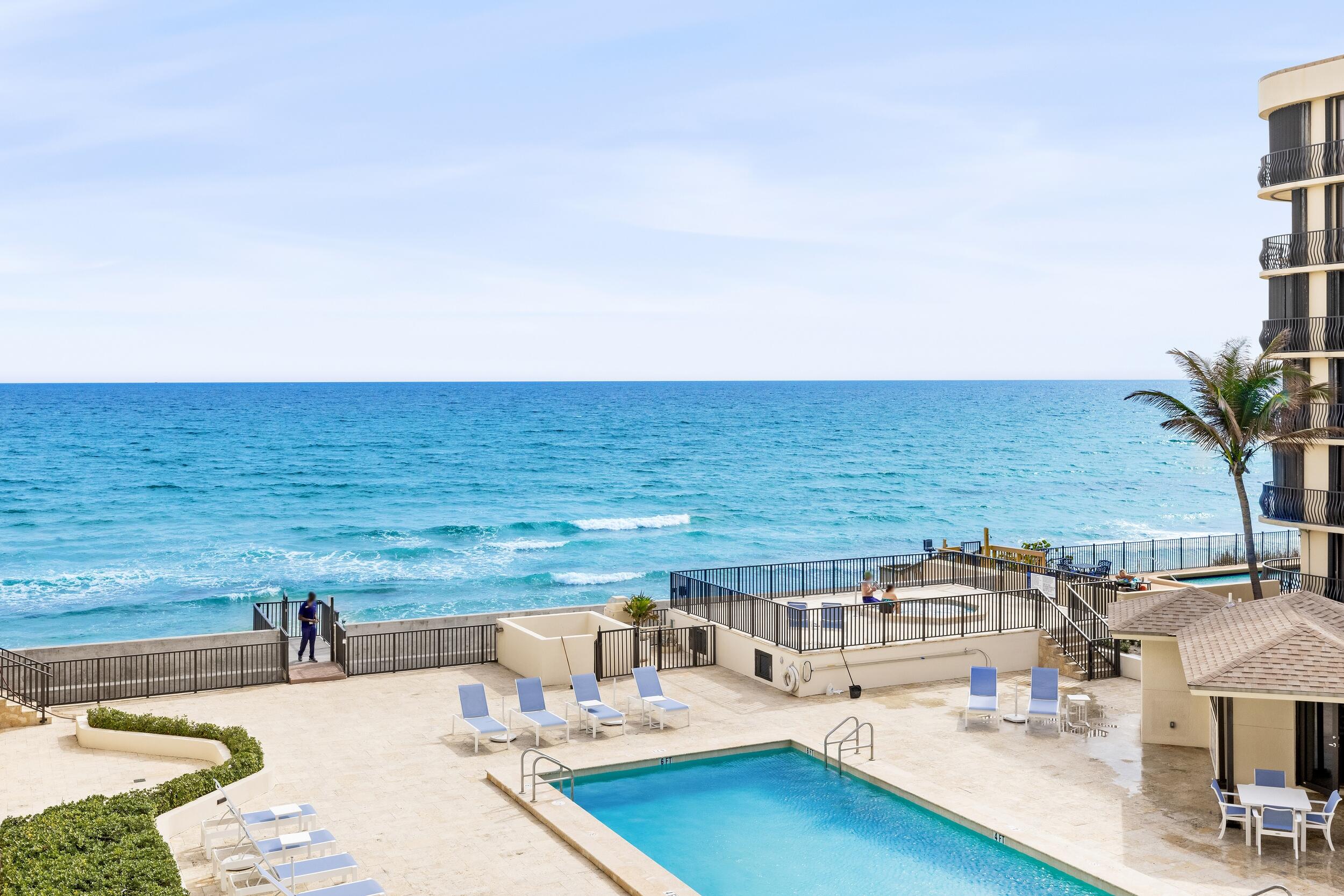 a view of a swimming pool with an outdoor seating