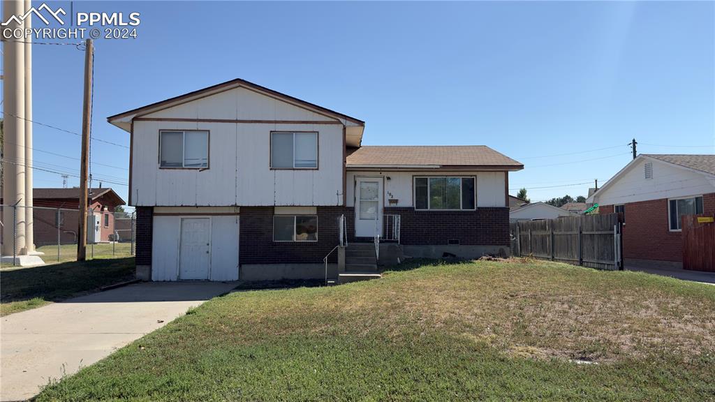 Tri-level home featuring a front lawn