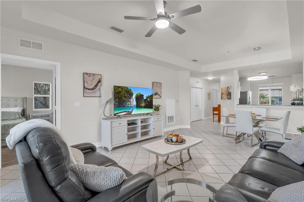 a living room with furniture and view of kitchen