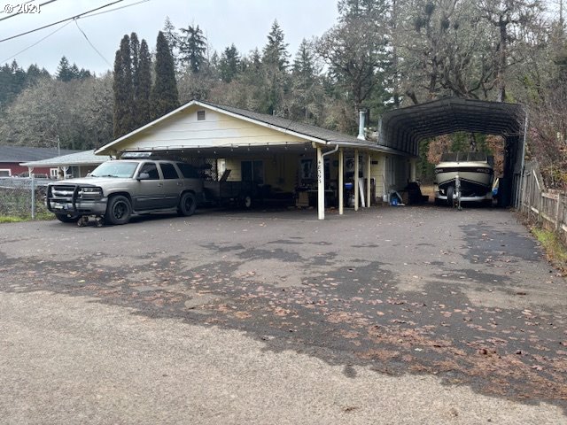 a view of a house with truck parked in front of house