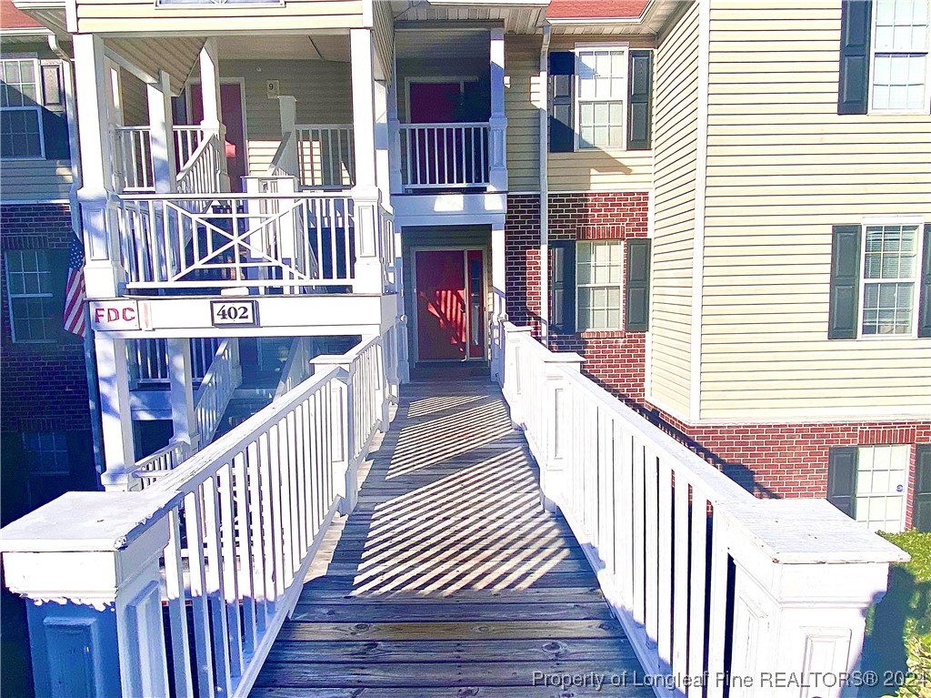 a view of a balcony with wooden floor and staircase