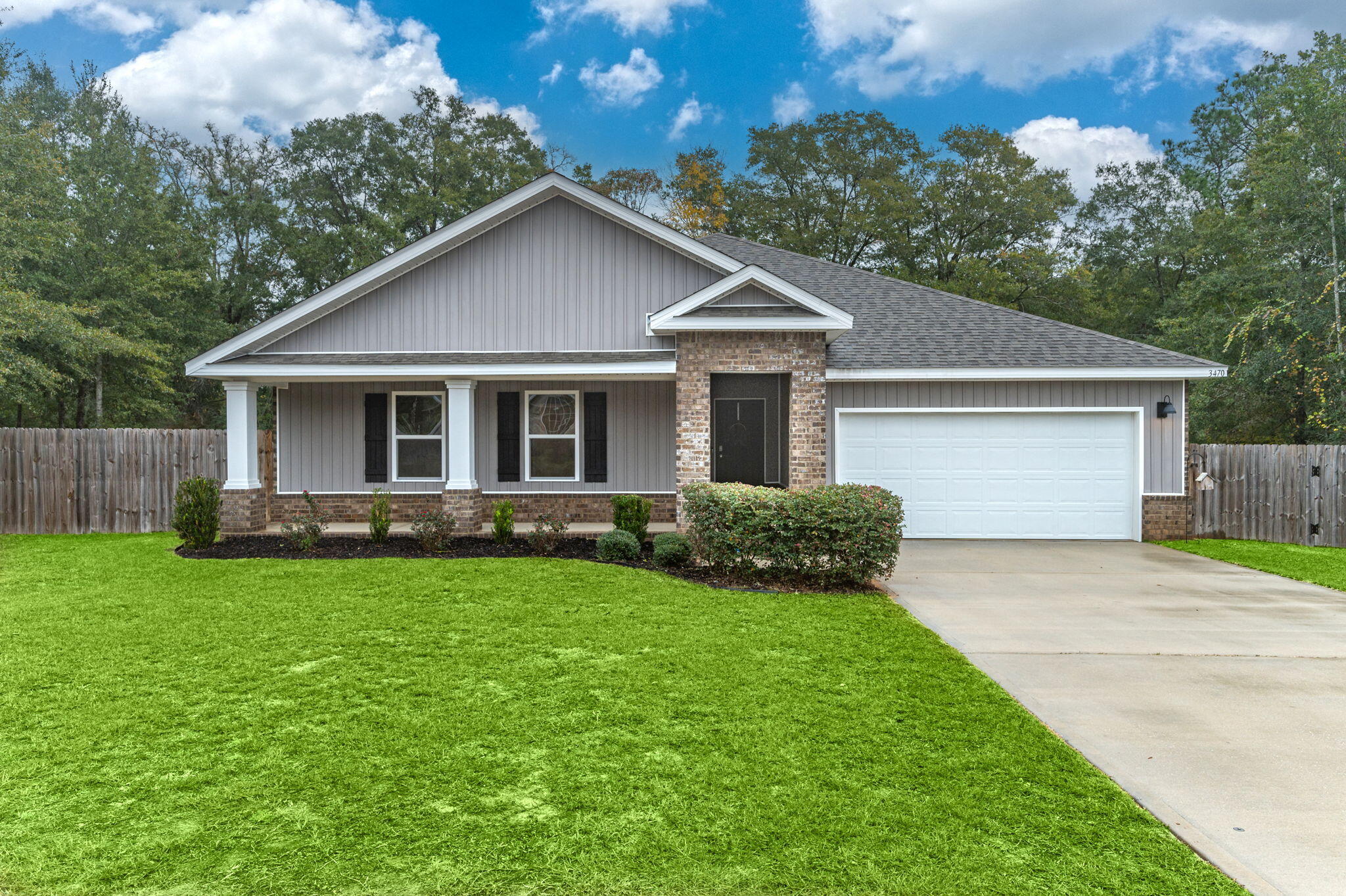 a front view of house with yard and green space