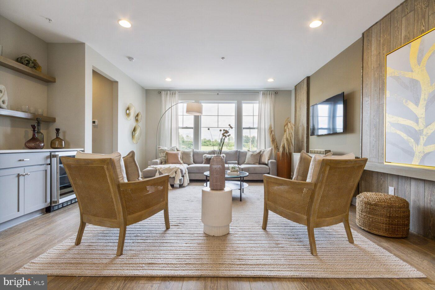 a living room with fireplace furniture and a large window