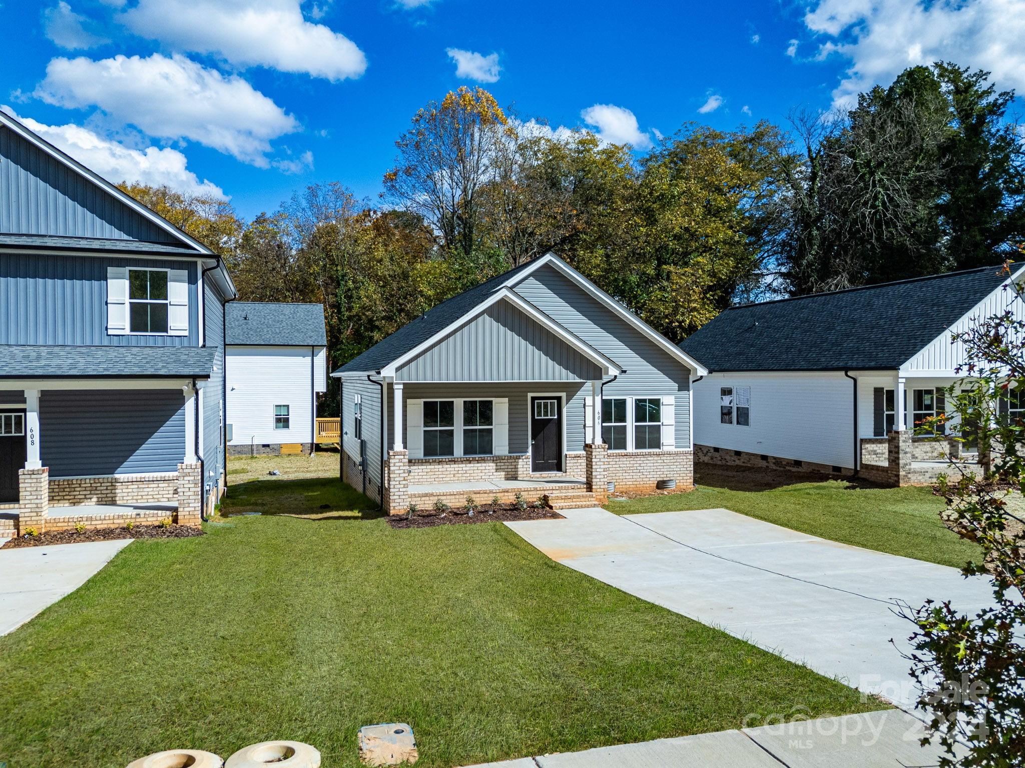 a front view of house with yard and green space