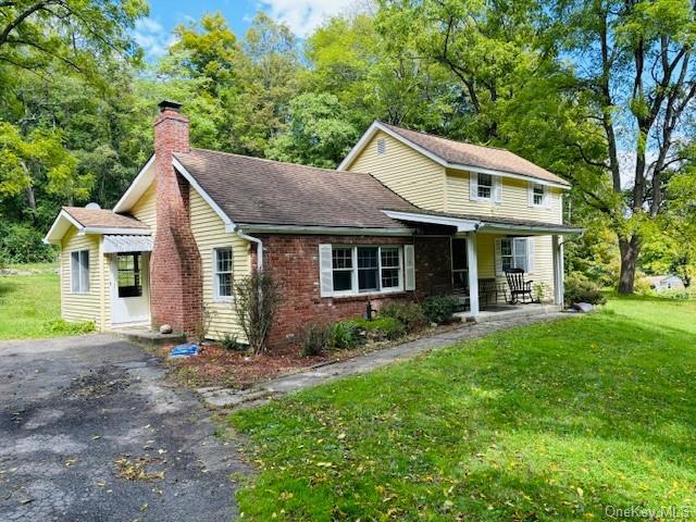 a front view of a house with a yard and porch