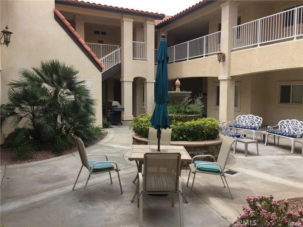 a view of a patio with table and chairs and potted plants