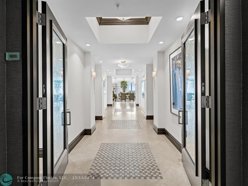 a view of a hallway with a livingroom and couch