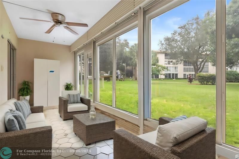 a living room with patio area and garden view