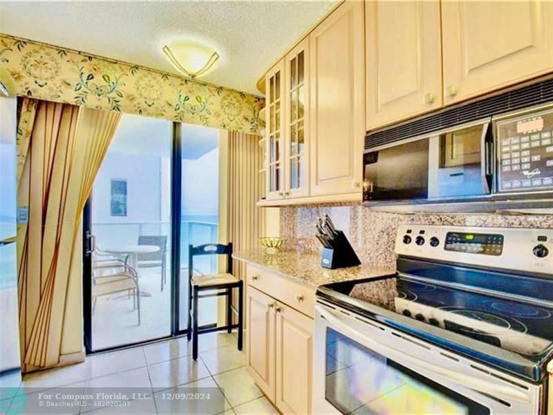 a kitchen with stainless steel appliances granite countertop a stove and a refrigerator