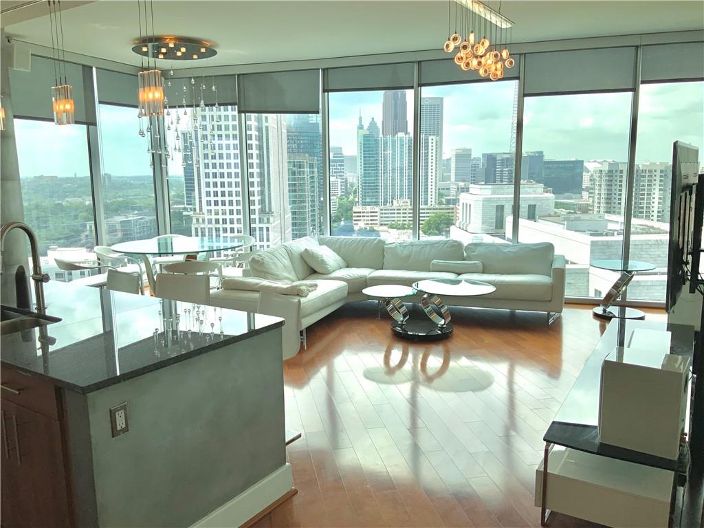 a living room with furniture and a floor to ceiling window