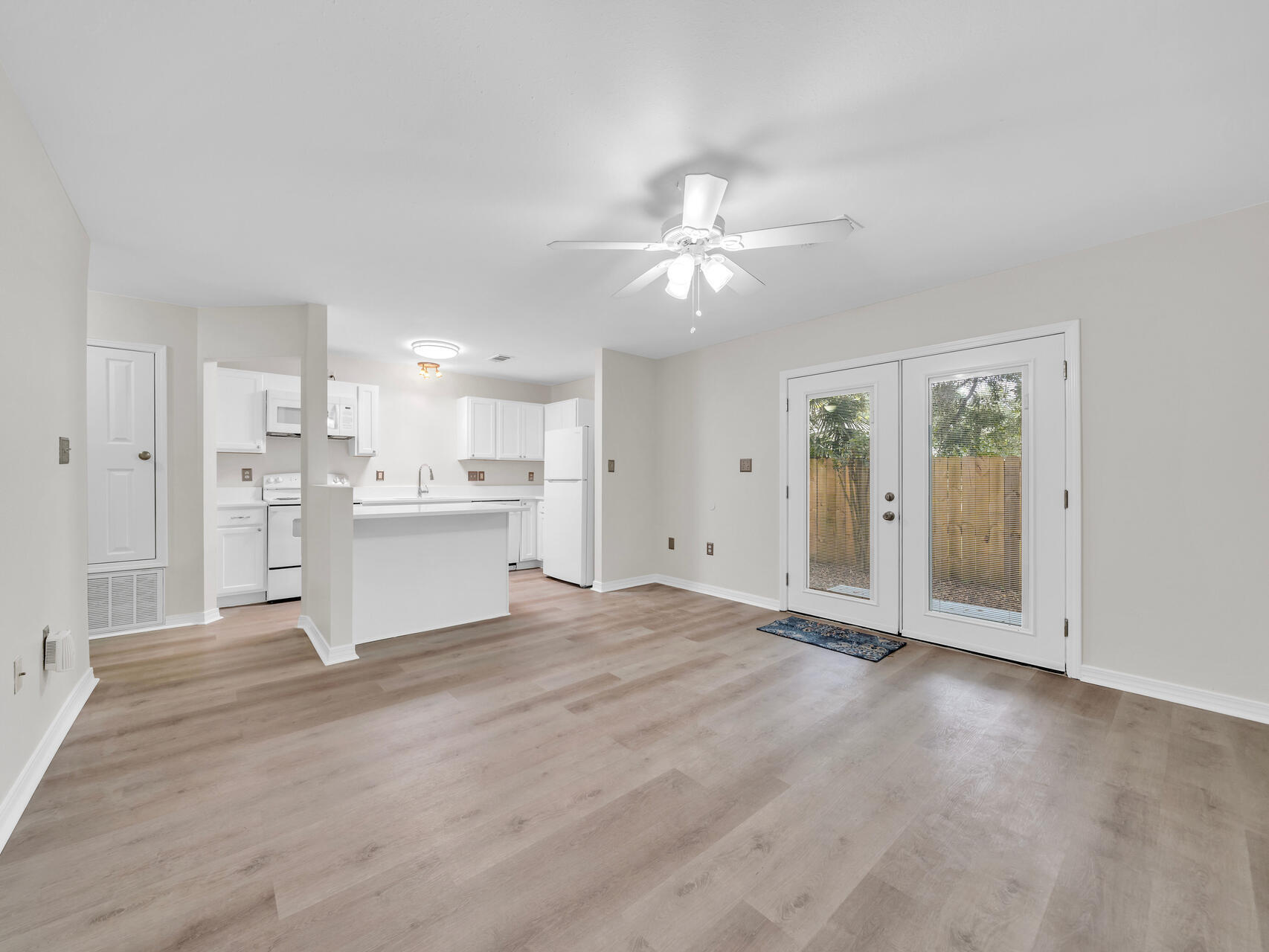 a view of a kitchen with an empty space and a window