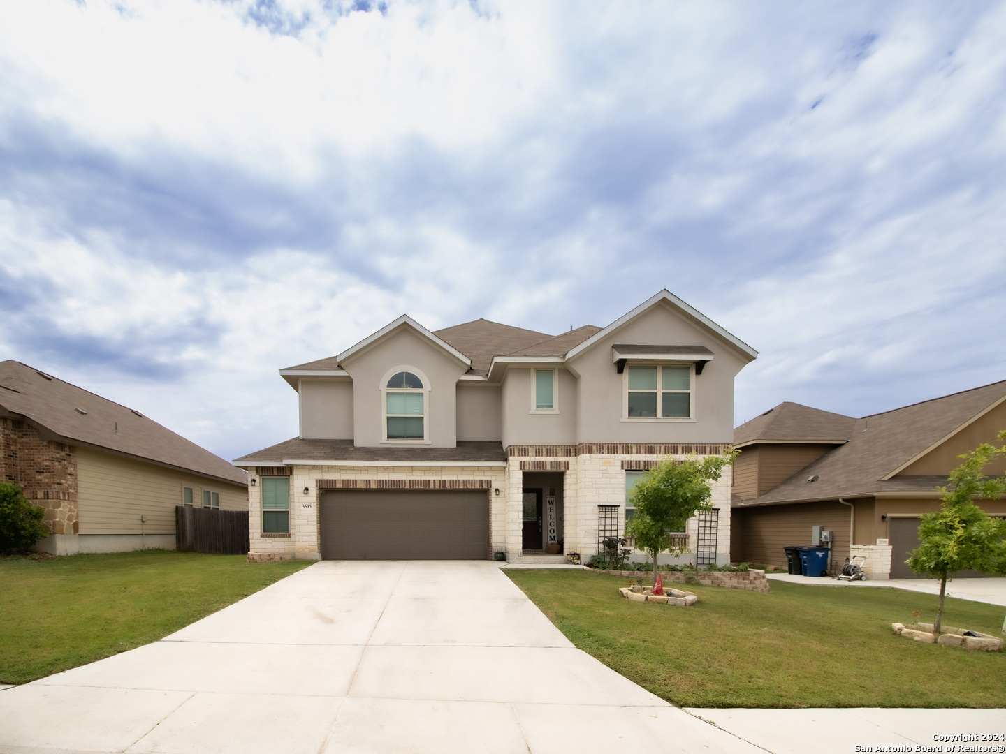 a front view of a house with a yard