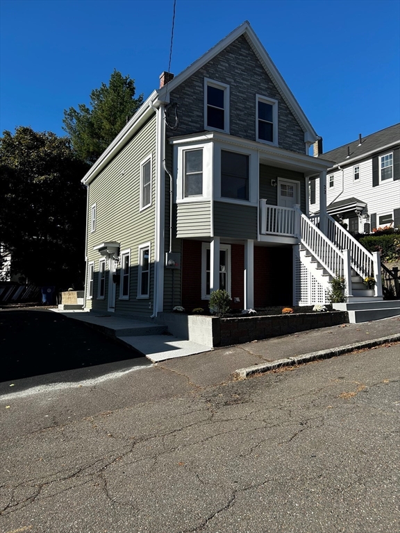 a front view of a house with a street