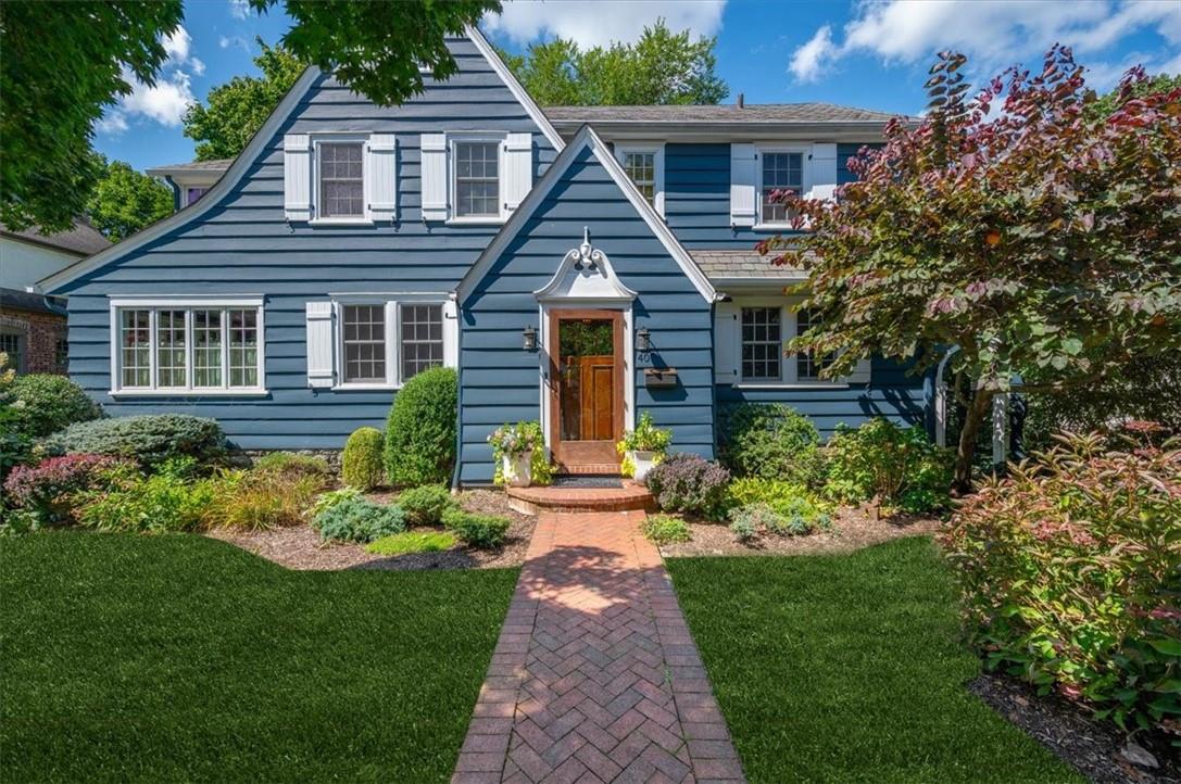 a front view of a house with a garden