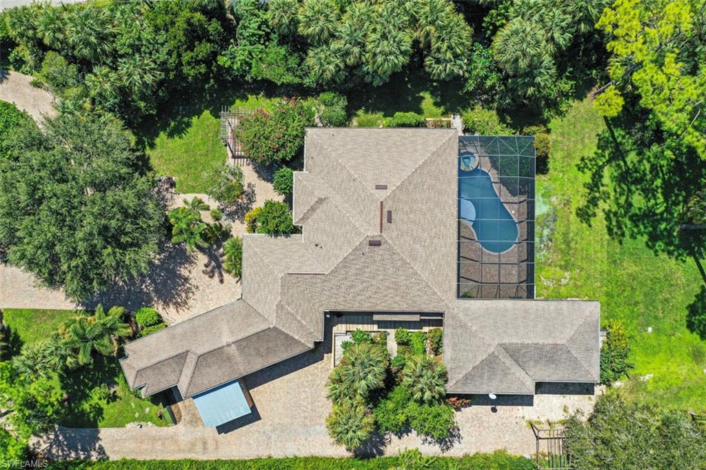 an aerial view of a house with a yard