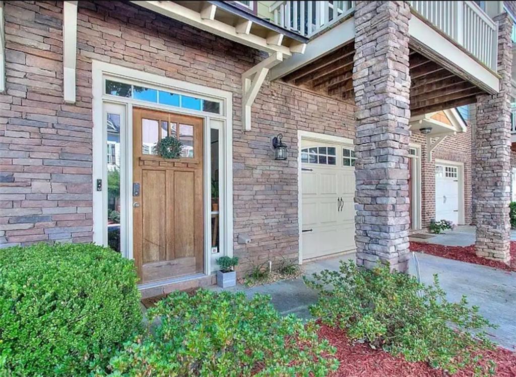 a brick building with a bench in front of door