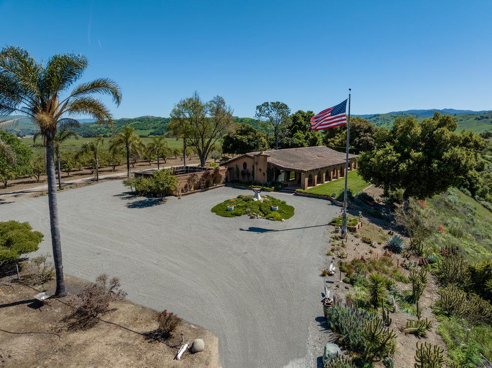 an aerial view of a house with outdoor space