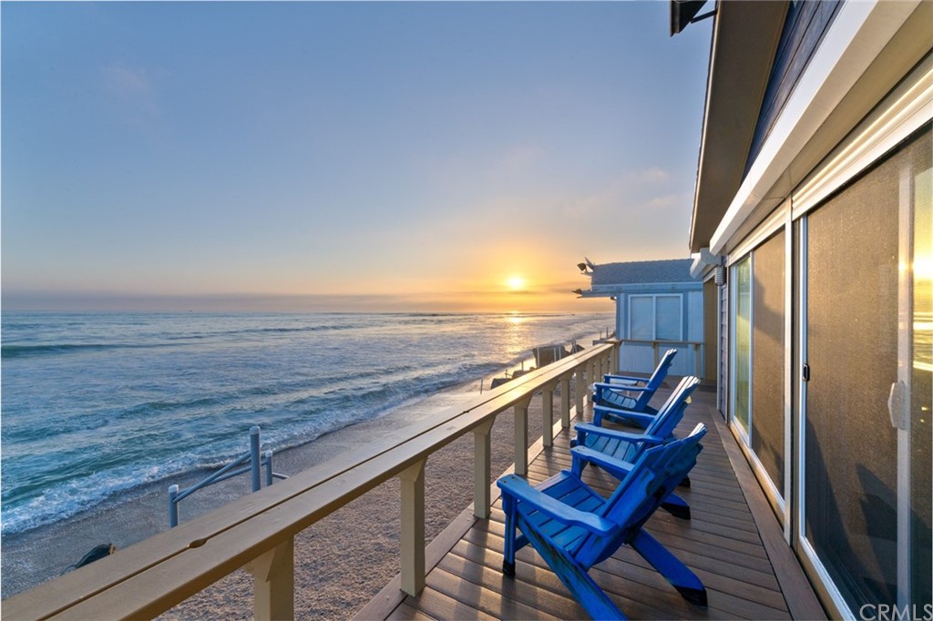 a view of roof deck with wooden floor and seating space