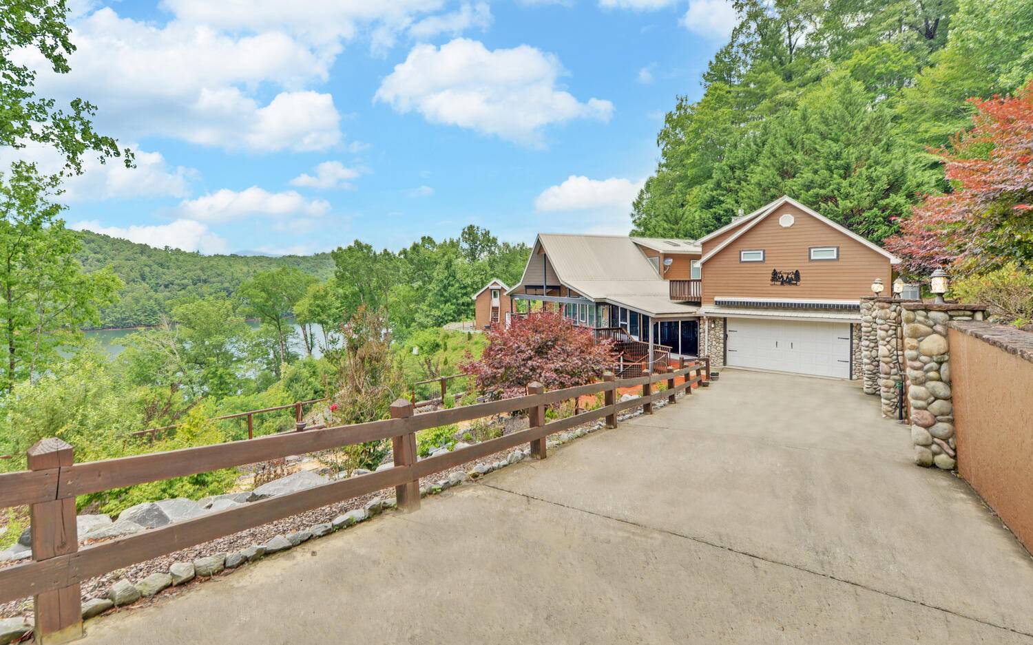 an aerial view of a house with wooden fence