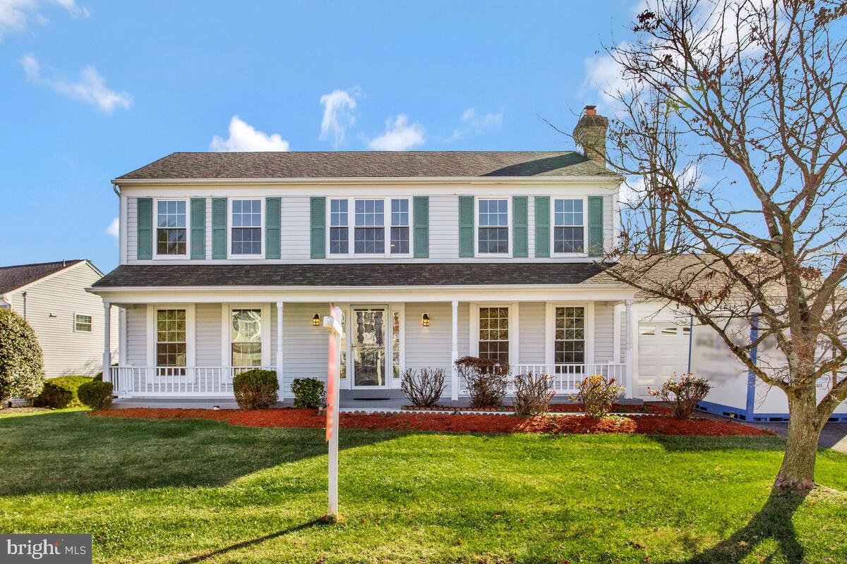 a front view of a house with a garden and yard