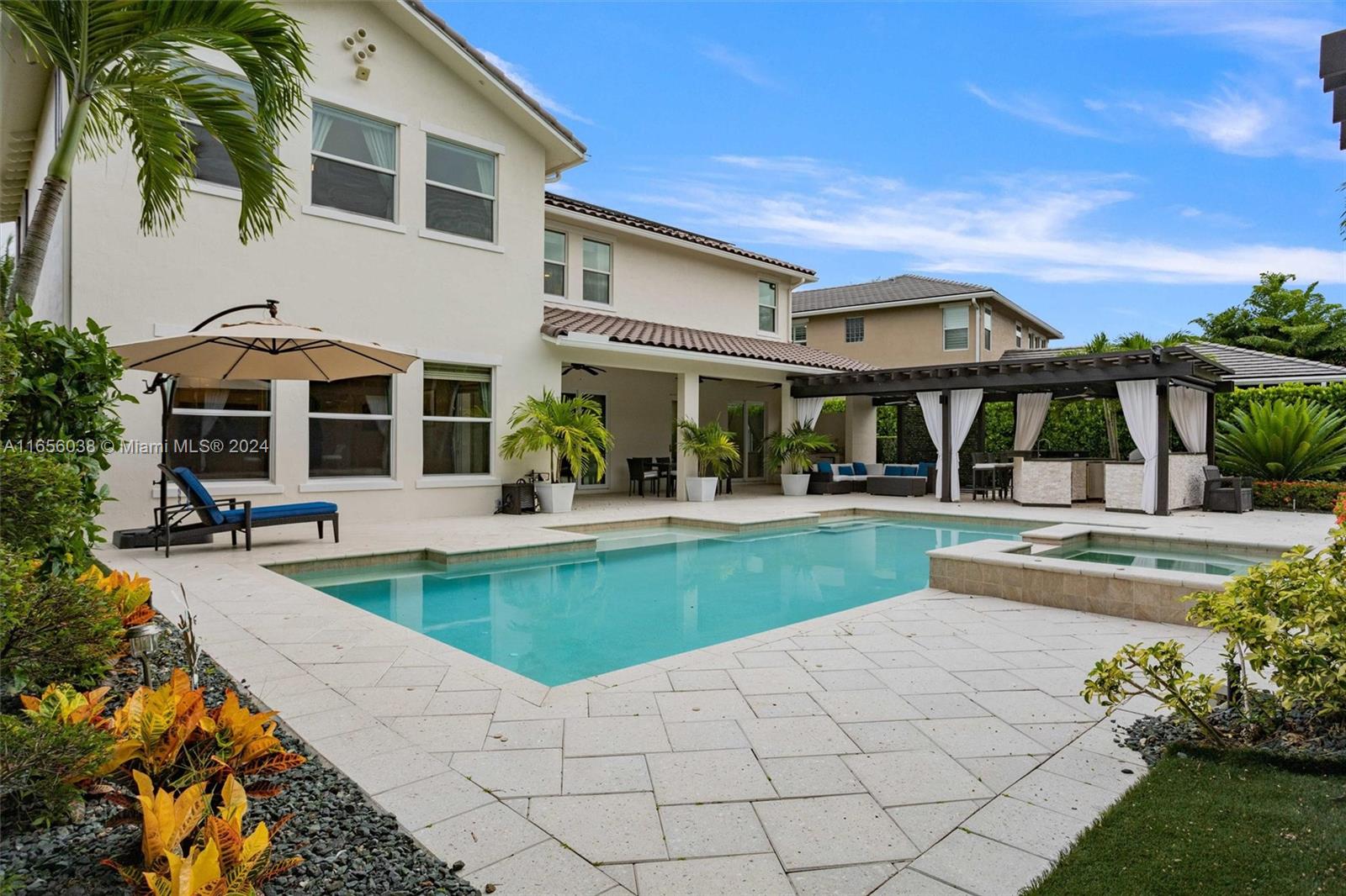 a view of a house with swimming pool and sitting area