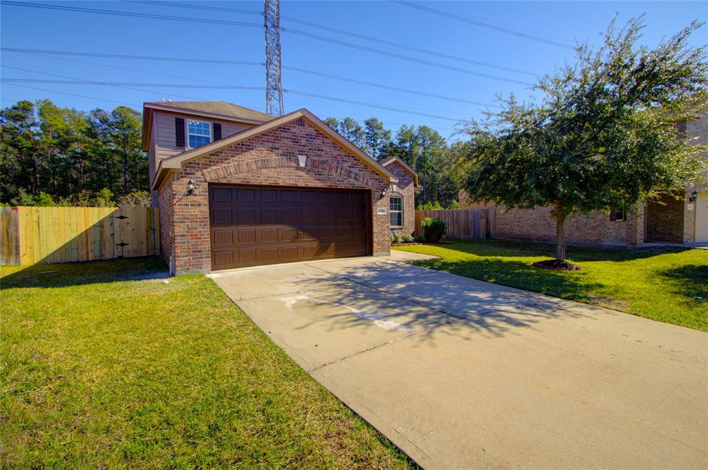 a view of a house with a yard and garage