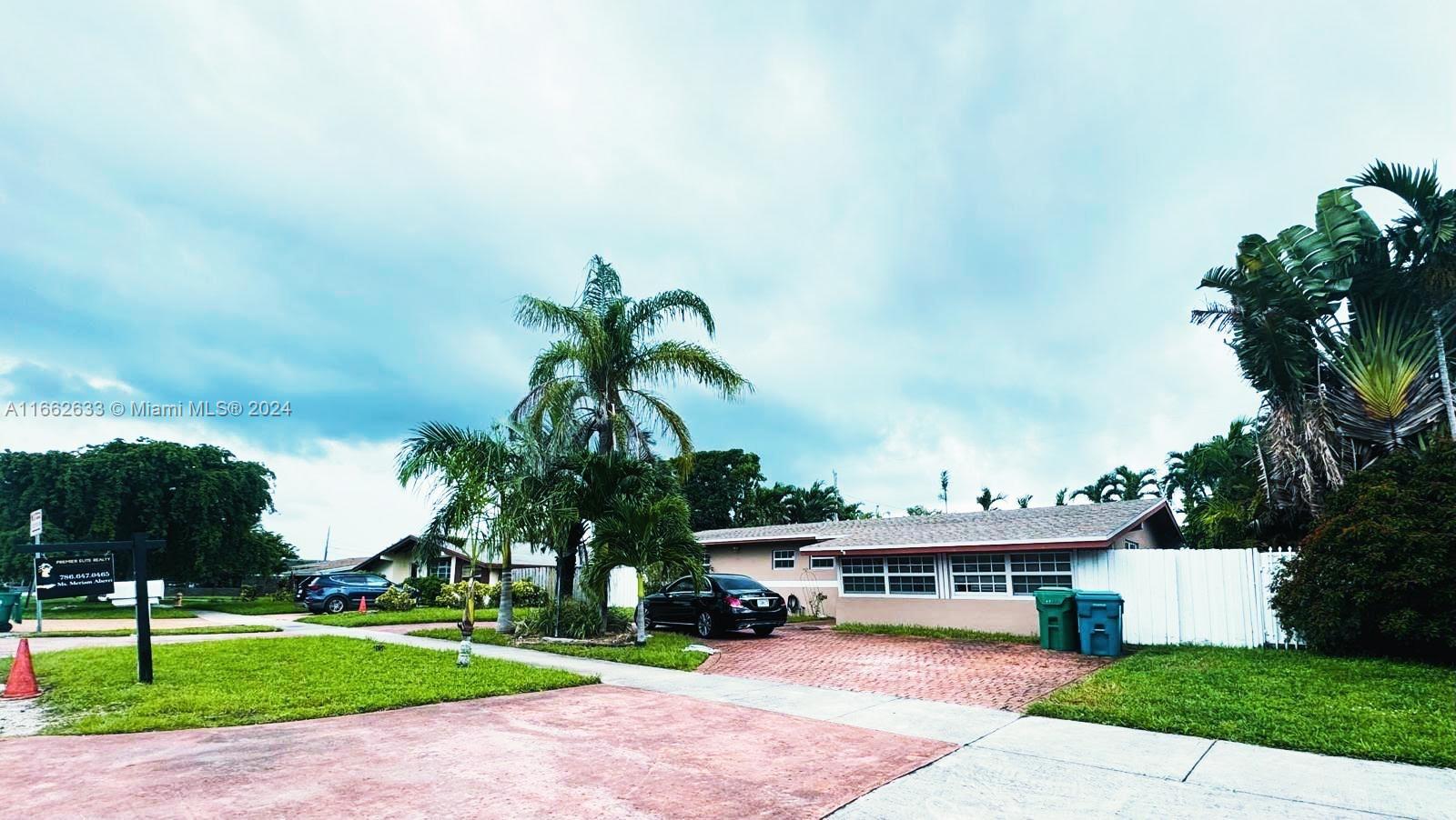 a view of a house with a swimming pool and a yard