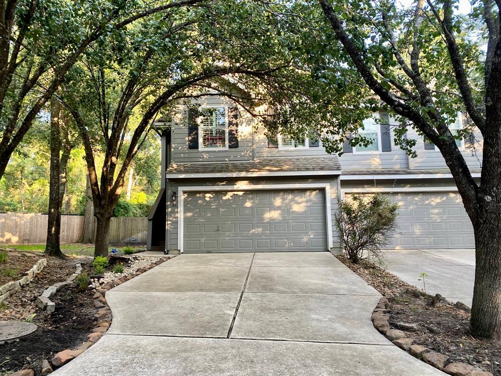 a front view of a house with yard and trees