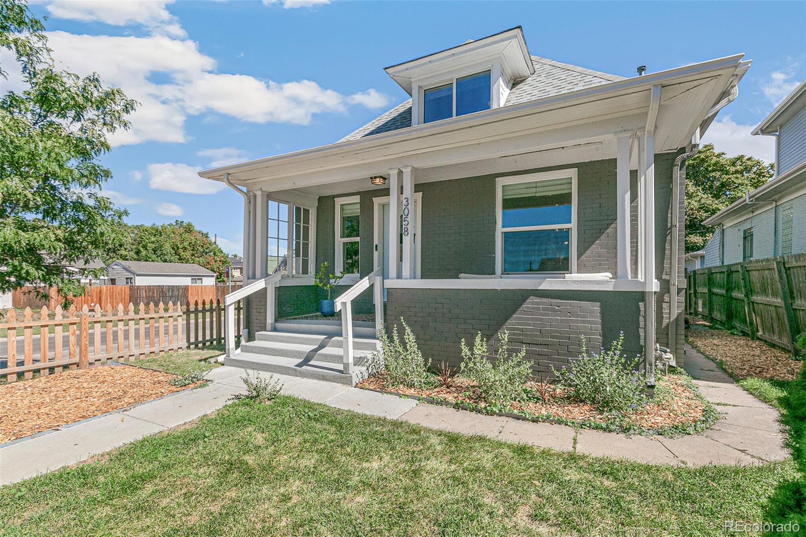 front view of a house with a yard