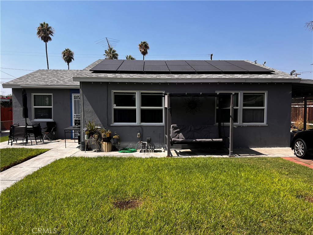 a view of a house with backyard porch and sitting area