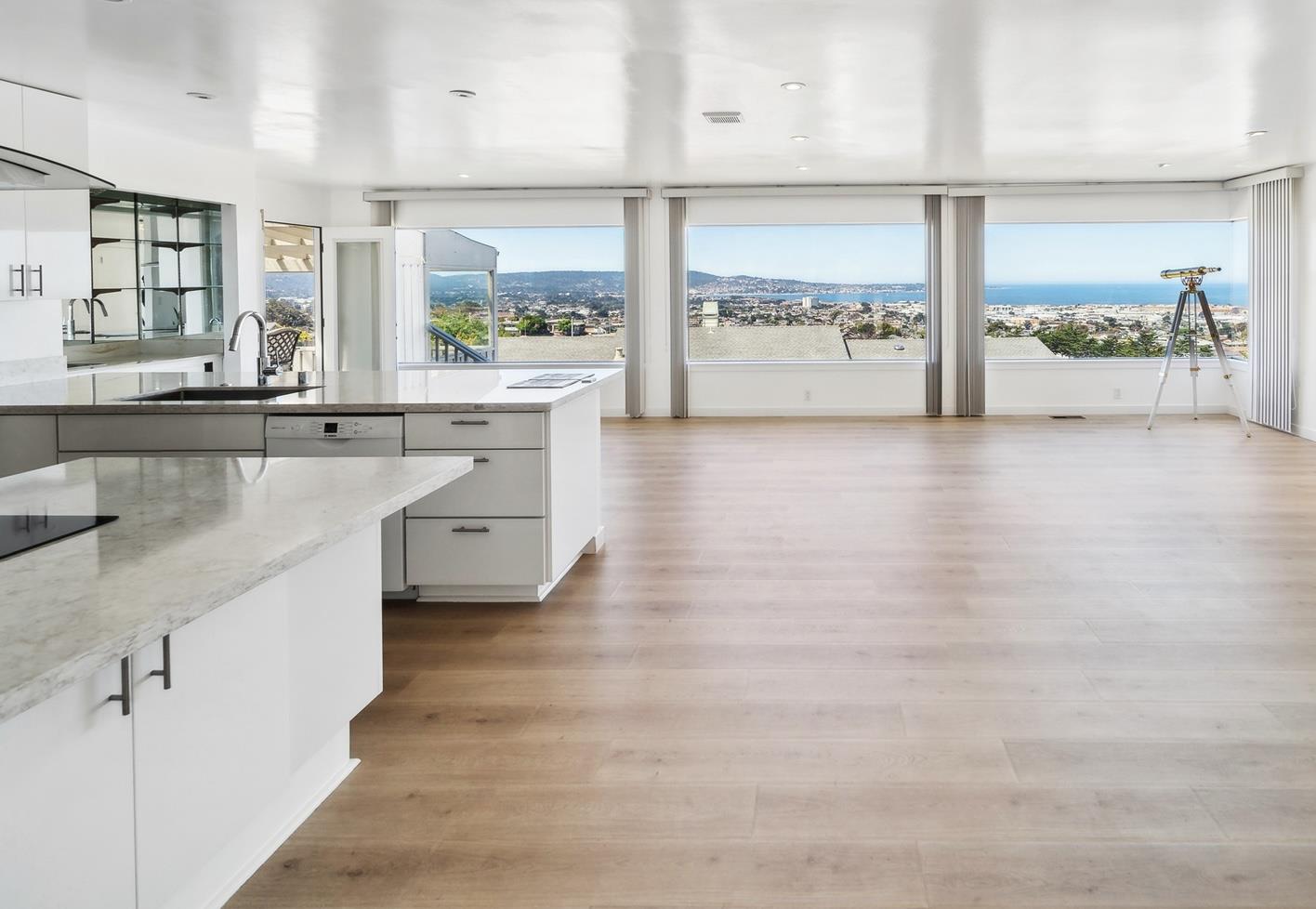 a large white kitchen with a large window