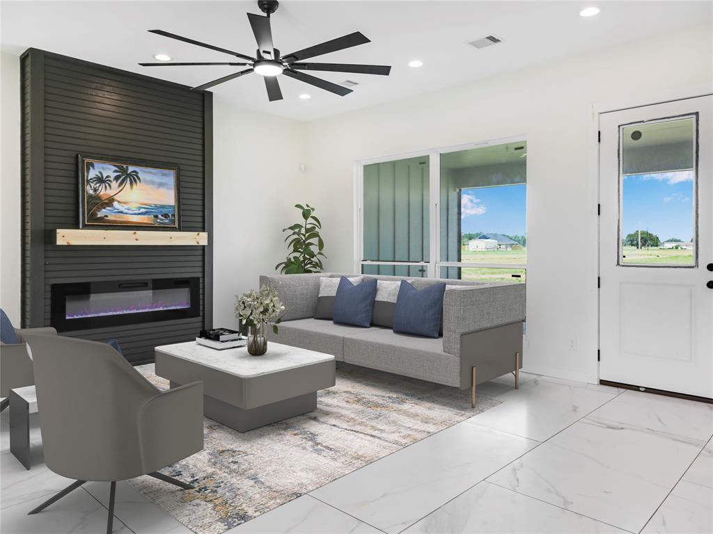 a living room with furniture a fireplace and a flat screen tv