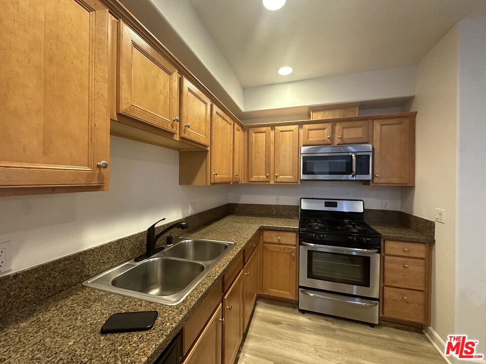 a kitchen that has a sink and a stove top oven