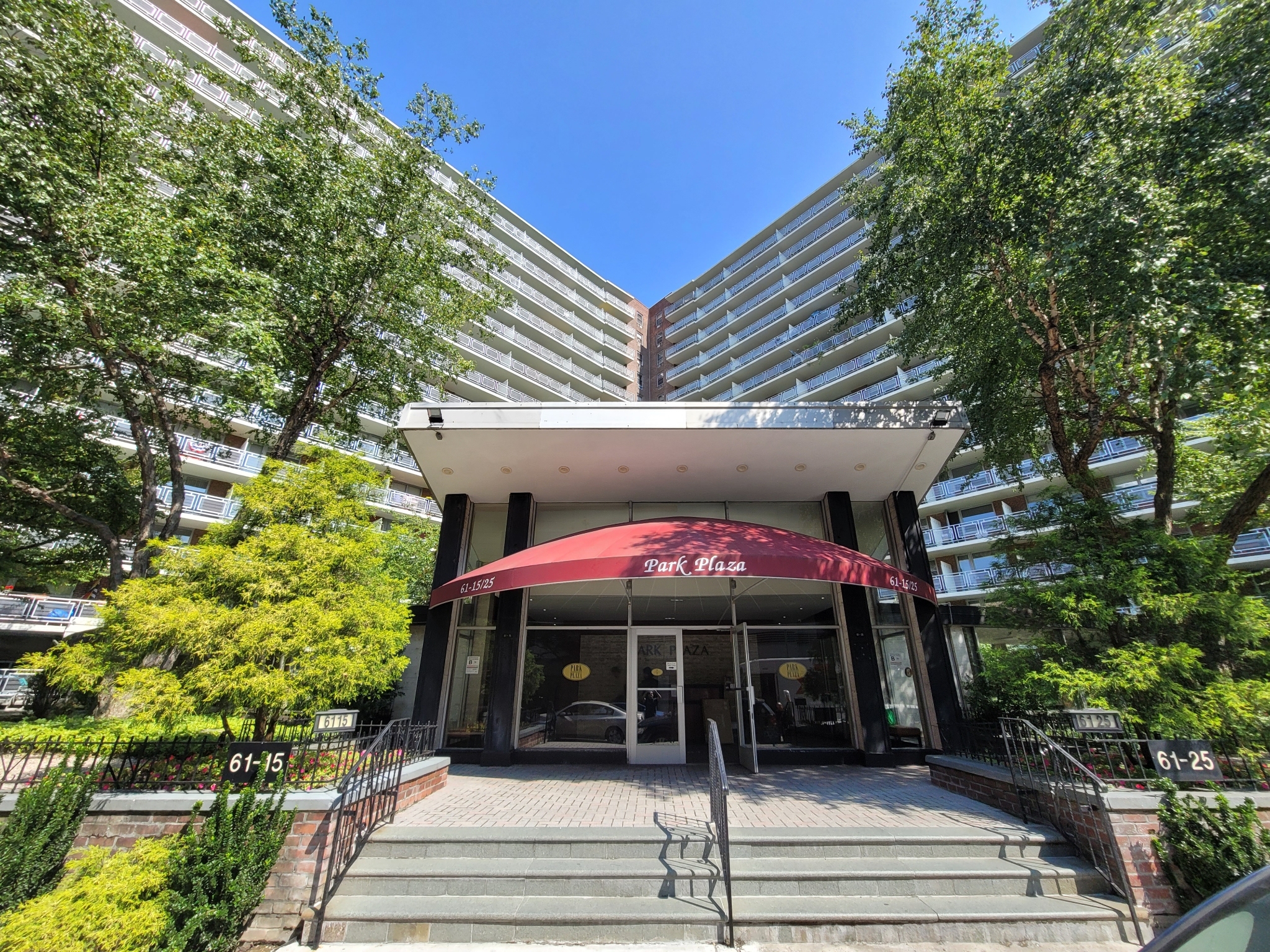 a front view of a building with a garden