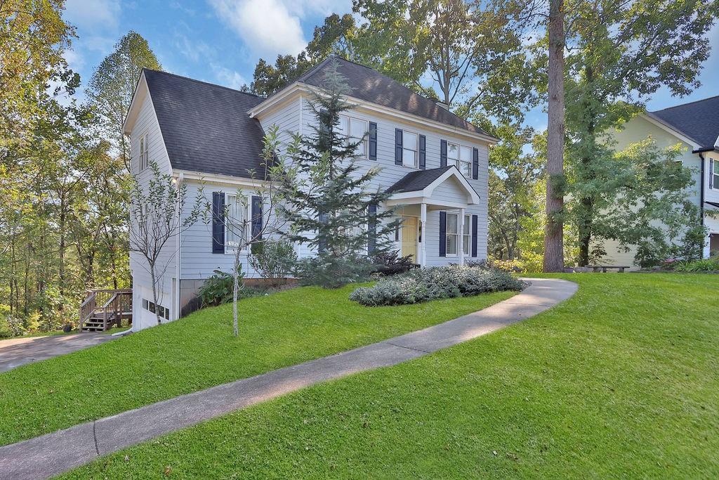 a front view of house with yard and green space