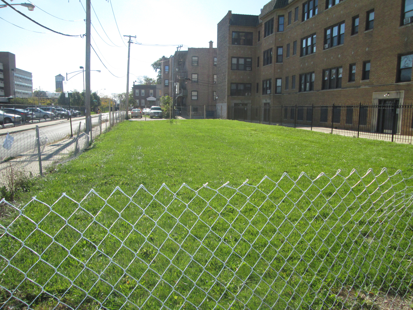 a view of a brick building next to a yard