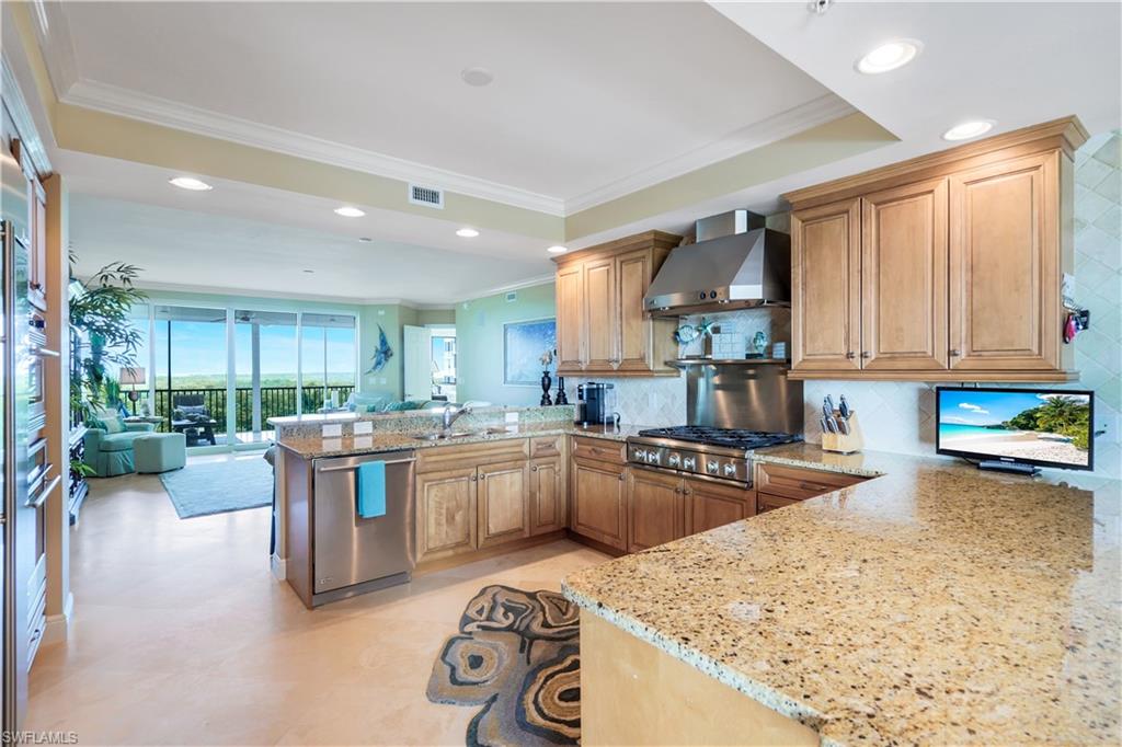 a kitchen with stainless steel appliances granite countertop a sink stove and refrigerator